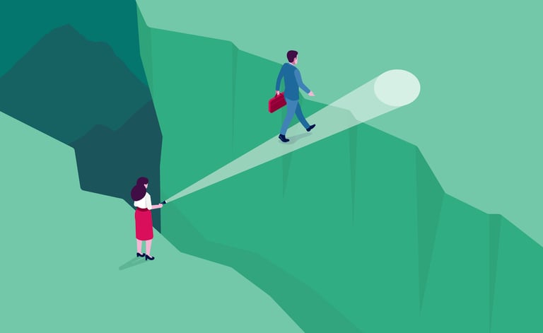 A woman holding a flashlight guides a man with a briefcase walking across a deep canyon.