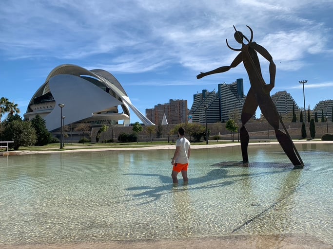 Man standing in water by the Art & Science Center in Valencia